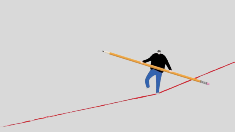 The image shows a person walking on a red line while holding a large pencil horizontally. The person appears to be balancing on the line, using the pencil for support.
