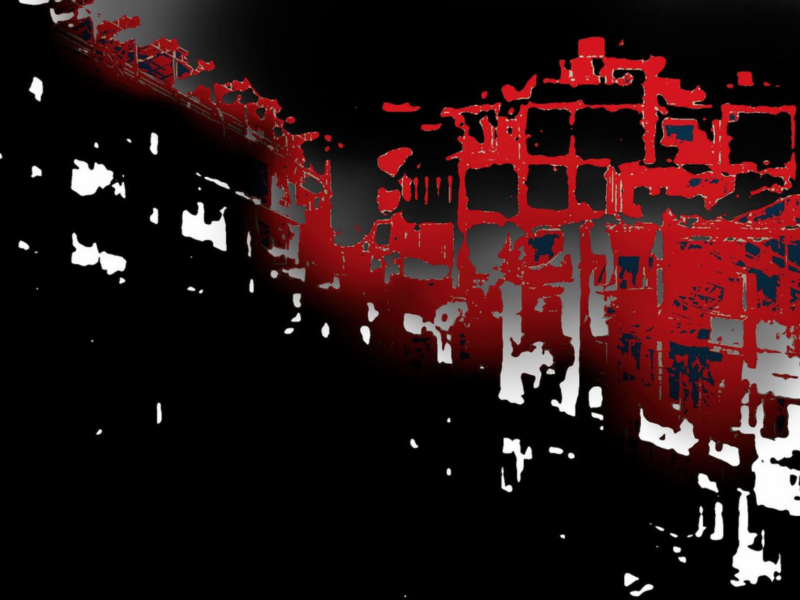 The image shows an abstract, high-contrast scene with a combination of black, white, and red colors. The shapes appear to be a mix of geometric forms and irregular patterns, possibly representing buildings or an urban landscape.