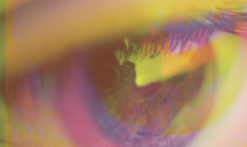 Close-up of an eye with a colorful, abstract overlay in shades of yellow, pink, purple, and green, creating a vibrant and blurred effect