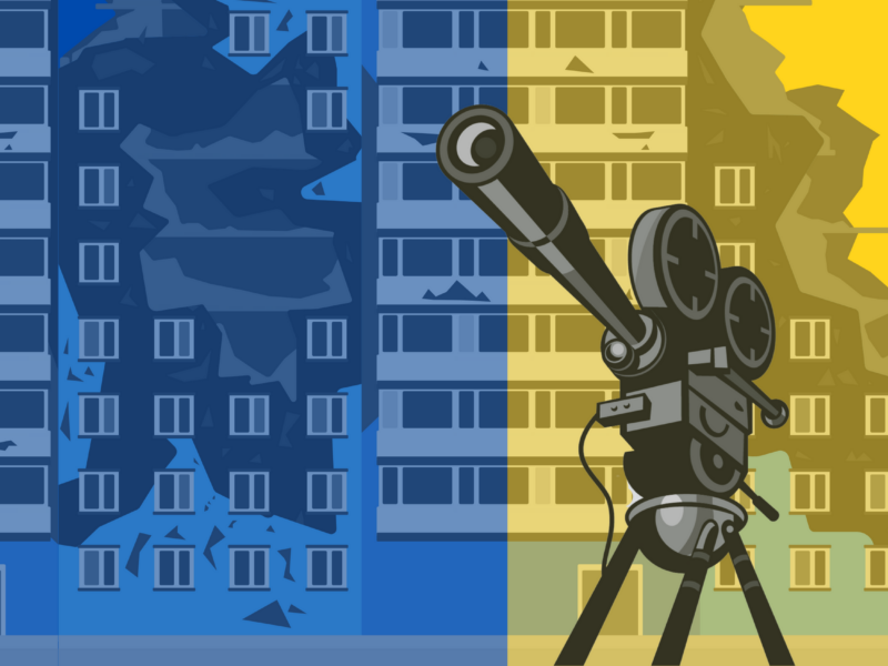 The image shows a stylized illustration of a film camera on a tripod in the foreground, with two buildings in the background. The buildings are depicted in blue and yellow colors, with the blue building on the left and the yellow building on the right. The buildings appear to be damaged or partially destroyed.