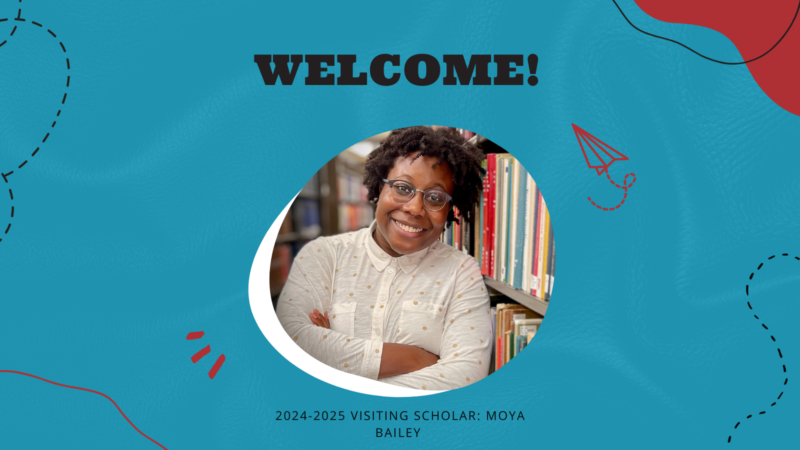 The image shows a person standing in front of a bookshelf with arms crossed. The background is blue with red accents, and there is text on the image that reads: "WELCOME! 2024-2025 VISITING SCHOLAR: MOYA BAILEY."