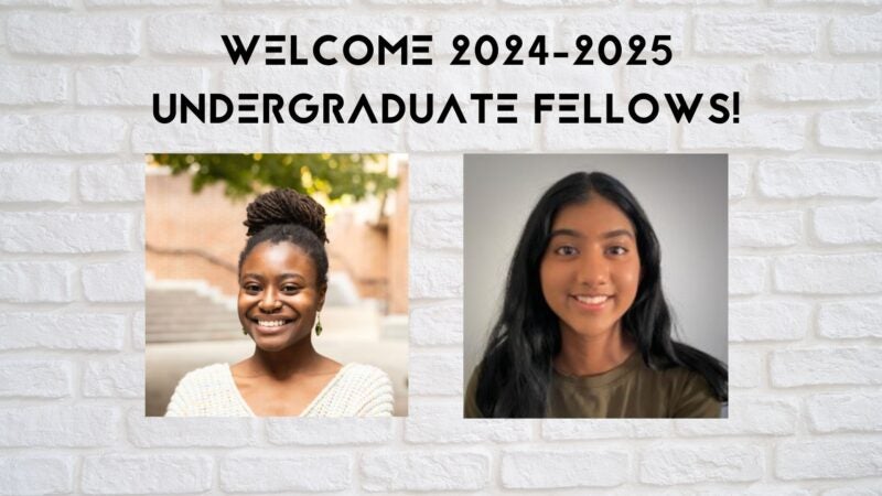 The image shows two individuals positioned side by side against a white brick wall background. Above the individuals, there is text that reads: "Center for Media at Risk Undergraduate Fellows".